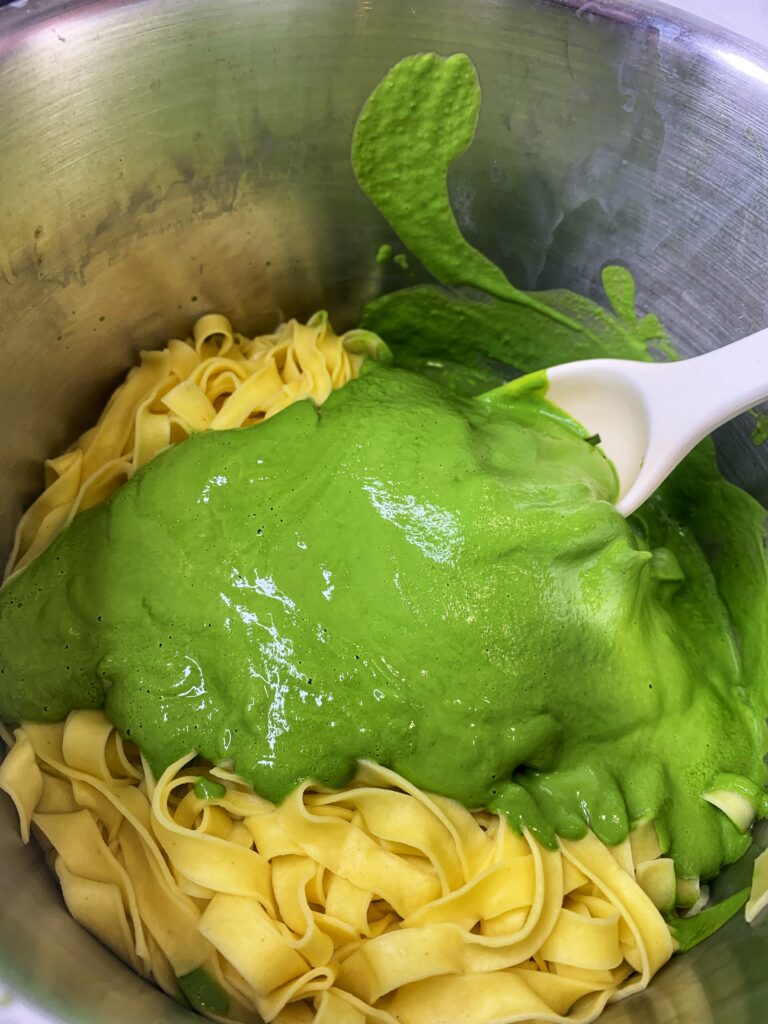 Pasta with bright green spinach pesto sauce