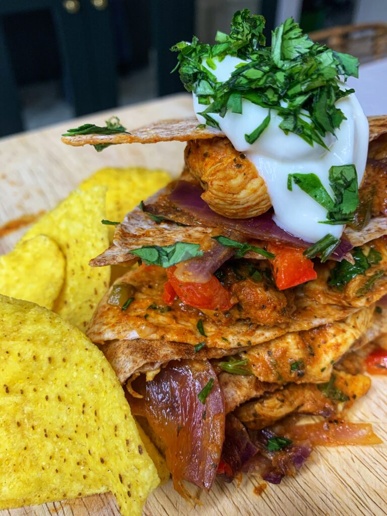 Oven baked chicken fajitas with sour cream and chips