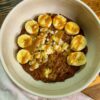 Brownie batter overnight oats, served with banana and tahini maple caramel