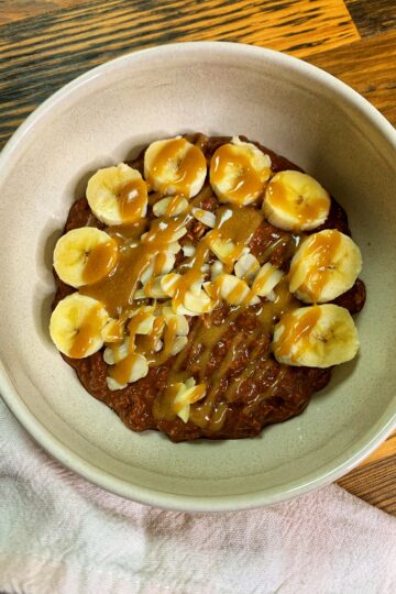 Brownie batter overnight oats, served with banana and tahini maple caramel