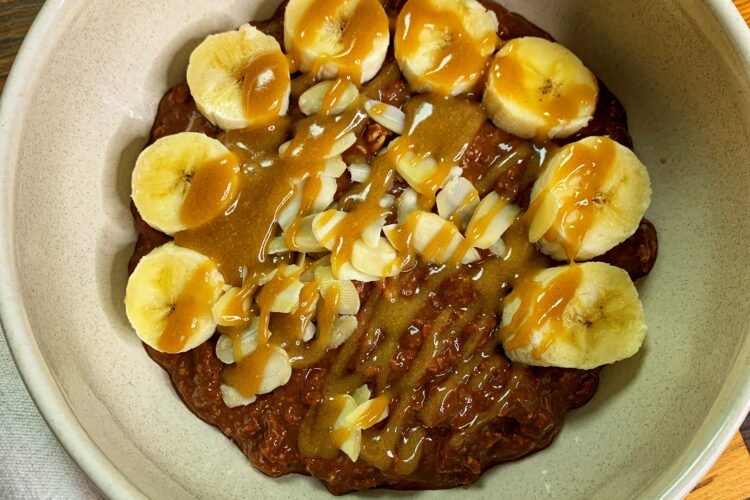 Brownie batter overnight oats, served with banana and tahini maple caramel