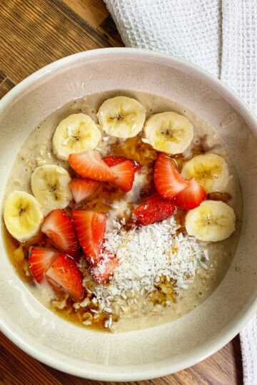 Bowl with cookie dough overnight oats with banana and strawberries